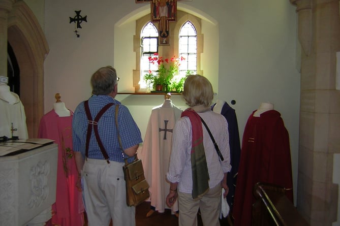 Visitors inspect the priest’s vestments on show at Our Lady of Lourdes Church in Haslemere