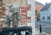 Street artist Hendog creates teddy bear on wall in Petersfield