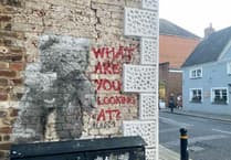 Street artist Hendog creates teddy bear on wall in Petersfield
