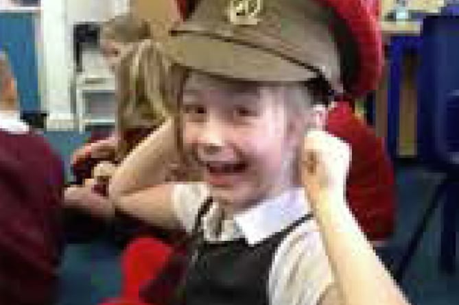 Bordon Infant School girl wears Army hat, November 2023.