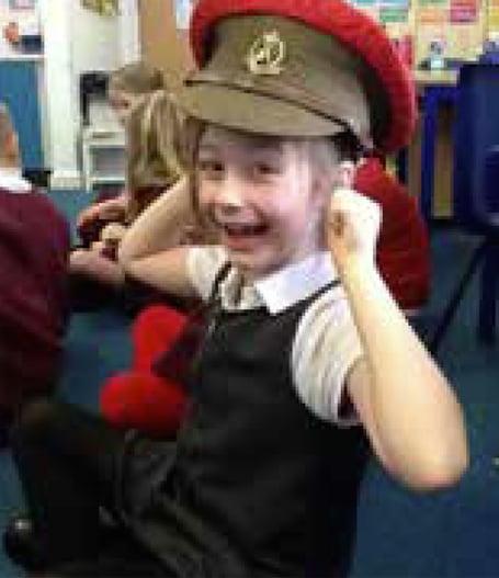 Bordon Infant School girl wears Army hat, November 2023.