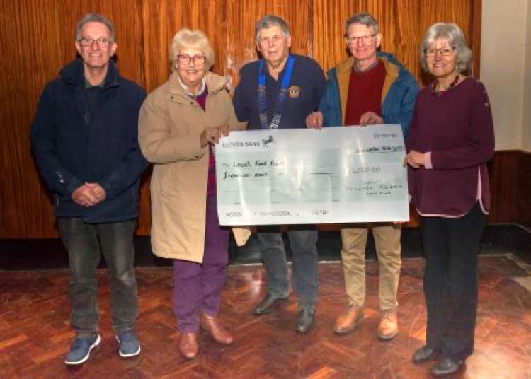 Woolmer Forest Lions acting president Richard Balchin hands over a £4,000 cheque to four local foodbanks. Pictured from left to right: Martin Firman (representing Bordon Foodbank), Pauline Firman (Headley Down Foodbank), Richard Balchin (Woolmer Forest Lions), Nigel Drury (Liss Foodbank) and Mary Braitch (Liphook Foodbank)