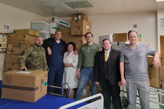 Hospital staff, and drivers Alex and Jordan (centre), with the UK consignment of medical supplies, December 24th 2023.