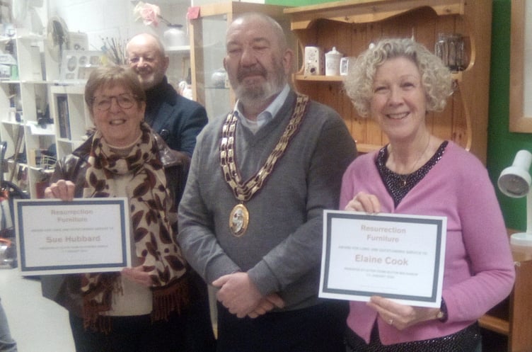 Sue Hubbard, left, and Elaine Cook receive long service certificates from Alton town mayor Cllr Ben Hamlin at Resurrection Furniture, High Street, Alton, January 11th 2024.