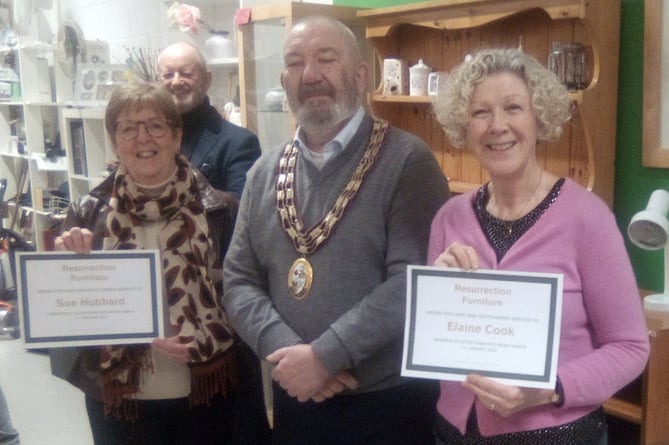 Sue Hubbard, left, and Elaine Cook receive long service certificates from Alton town mayor Cllr Ben Hamlin at Resurrection Furniture, High Street, Alton, January 11th 2024.