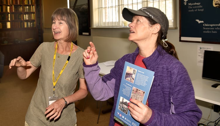Debbie Vodden, a volunteer at Gilbert White’s House in Selborne, helps a visitor, February 2024.