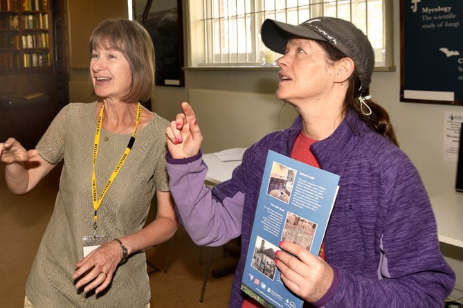 Debbie Vodden, a volunteer at Gilbert White’s House in Selborne, helps a visitor, February 2024.