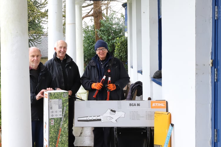 Museum volunteers with the garden tools donated by local businesses