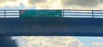 Anti-homes banner over A31 at Alton, March 2024.