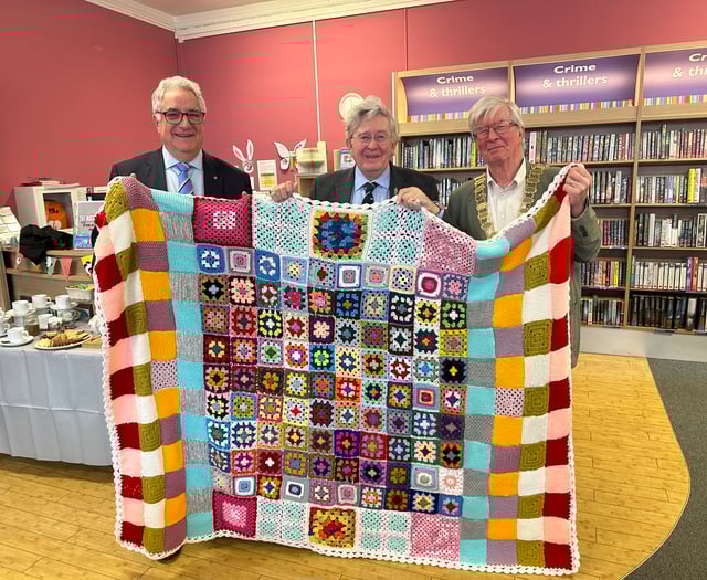 Library donates community handcrafted blankets to charity auction