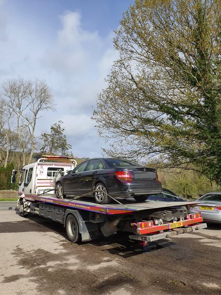 A black Mercedes C220 after being seized by police in Haslemere