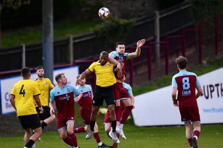 Farnham Town skipper Ryan Kinnane wins a header against Cobham