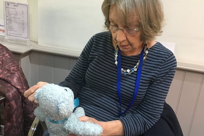 Denise Holmes re-stuffing the blue teddy.