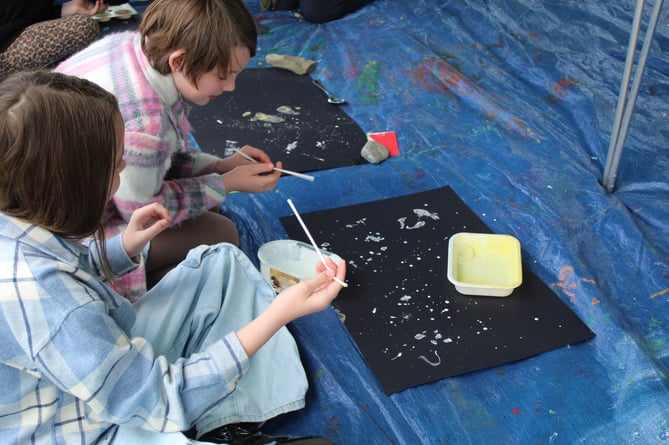 Children participating in painting activities.