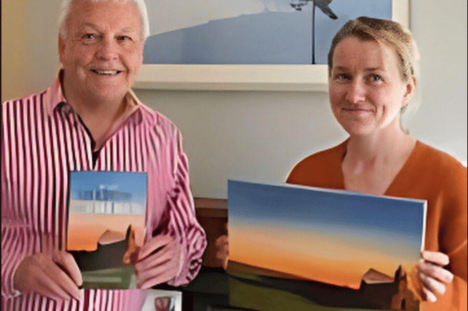 Colin Short and Kirsty Rouse with the book cover design. Behind them is a picture from Kirsty's travels in Rwanda.