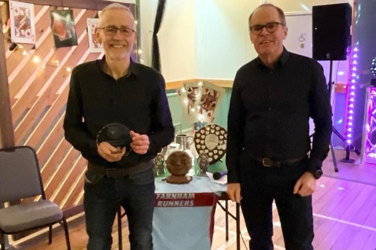 Chris Raby (left) with the trophy for the most personal bests, presented by Justin Clarke