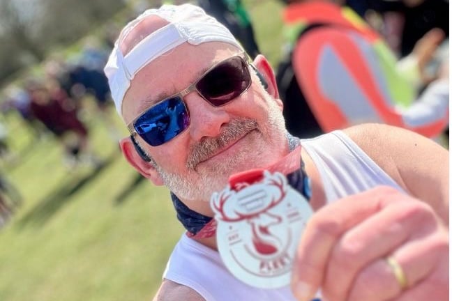 Steve King shows off his Fleet half marathon medal