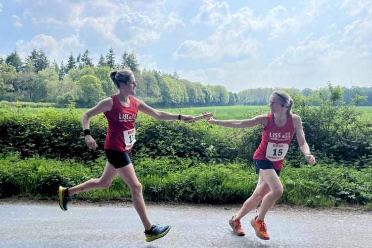 Gemma Sills (left) and Sarah Page pass the baton on the Emsworth to Basingstoke relay