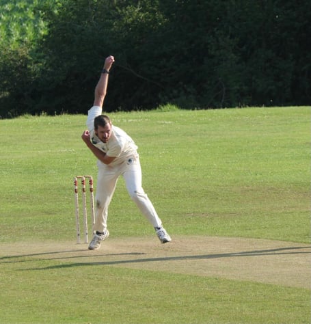 Tilford bowler Huw Town-Jones in action