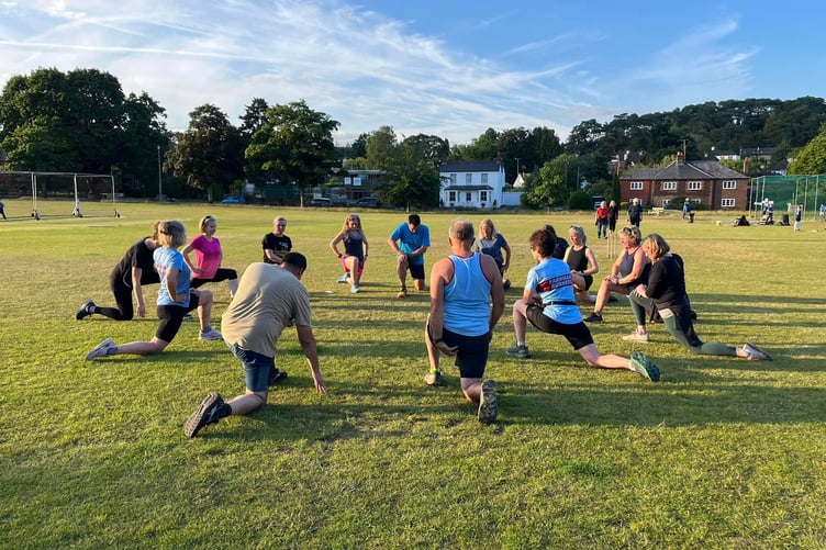 Farnham Runners stretch on the Bourne Green after a Get Me Started session
