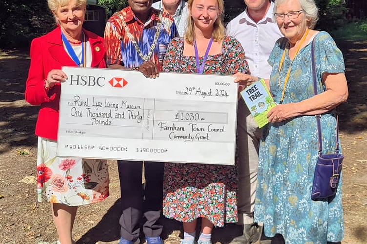 Mayor Mauluka presents the check to the museum's staff and volunteers