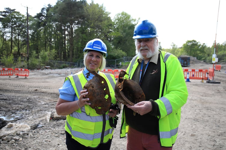 Justine Hope, Site Manager at Bellway’s Perceval Grange, and Dave Rudwick, local historian, with WW2 helmets from Midhurst Society