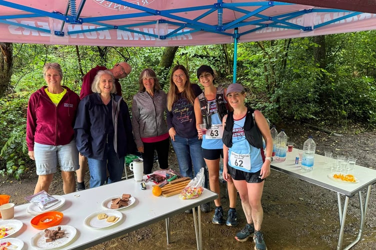 Farnham Pilgrim Marathon helpers Jacquie Browne, Alison Buchanan, Chris Gill, Penny Schnabel and Debbie Moorcroft with runners Meg Grocott and Colette Grist
