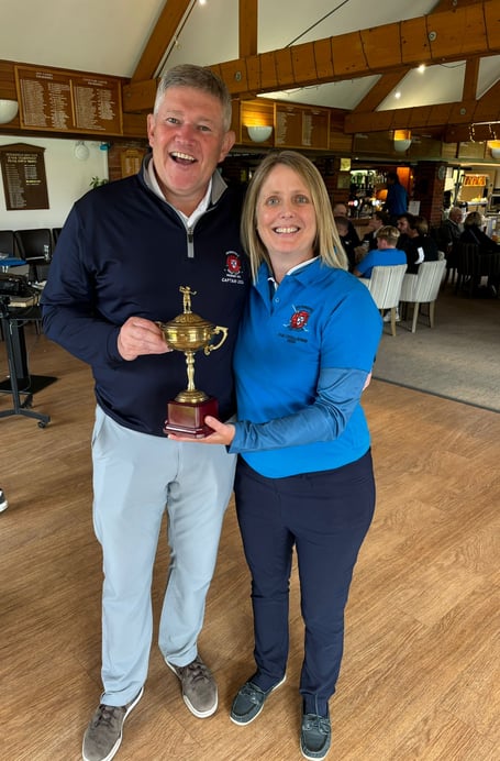 Petersfield Golf Club captain Simon Baigent presents Team Blue’s Katie Laud with the Challenge Trophy