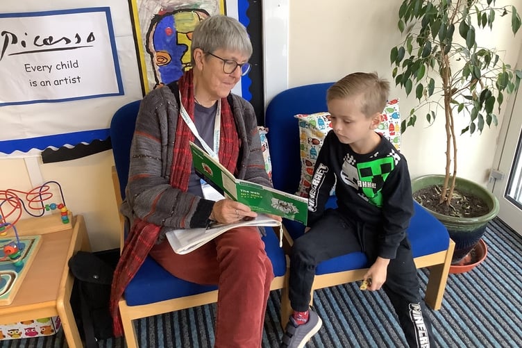 Alison Bosence, a Schoolreader volunteer at Wootey Infants School in Alton with Year 1 student Presley