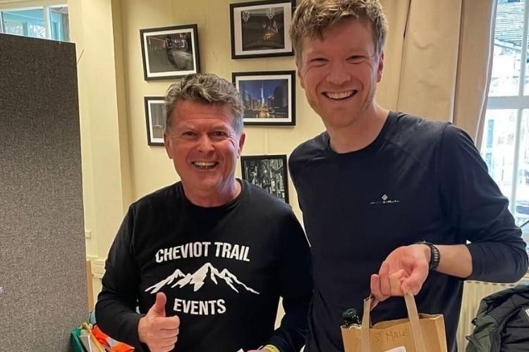 A triumphant Duncan Selmes receives his reward for winning the Tour de Humbleton trail race