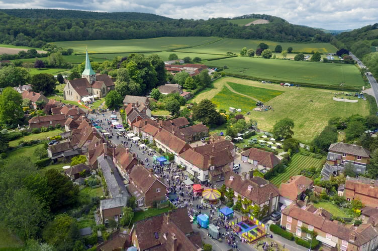 Villagers in the South Downs hamlet of South Harting in West Sussex gather for the Harting Festivities held on this bank holiday date each year. Sheep dog displays can be seen in the field on the right.  Since 1880 the West Harting Old Club has its annual meeting on Whit Monday. The festivities started in 1961. The village is near the National Trust home of Uppark where HG wells often stayed.
The village was used in the 1950âs in a promotional film to show quintessential English life to the Commonwealth. NOTE: **All permissions have been granted for this drone image from CAA/Land owner and festival organisers.** Photograph By Chris Gorman/Big Ladder. 27th May 2019.