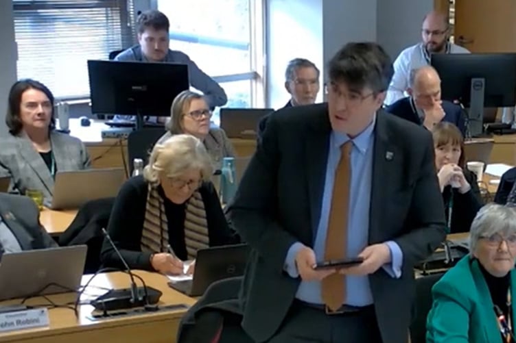 Cllr Paul Follows proposes higher council taxes for Band H properties at a meeting of Surrey County Council.