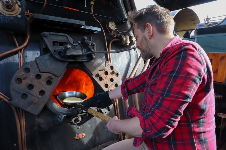 Railway historian Tim Dunn cooks pancakes on Canadian Pacific's boiler.