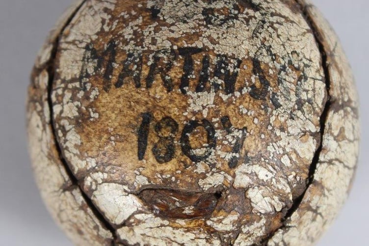 An old leather-bound featherie golf ball due to go under the hammer has presented a conundrum for auctioneers - and it is set to fetch up to £10k. Photo released April 27 2025. The early leather-bound feather golf ball was consigned for sale from a house move in Old Woking in Surrey and John Nicholsons auctioneers will sell it on May 14. The auctioneers said the family heirloom is inscribed stamped King James VI Club. Perth to one side, and 1807 Martins?? 1807 to the other  the inscriptions appearing under much wear and tear to the ball.