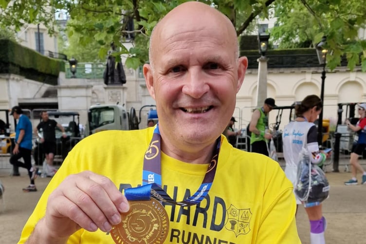 Richard Bravery shows off his medal