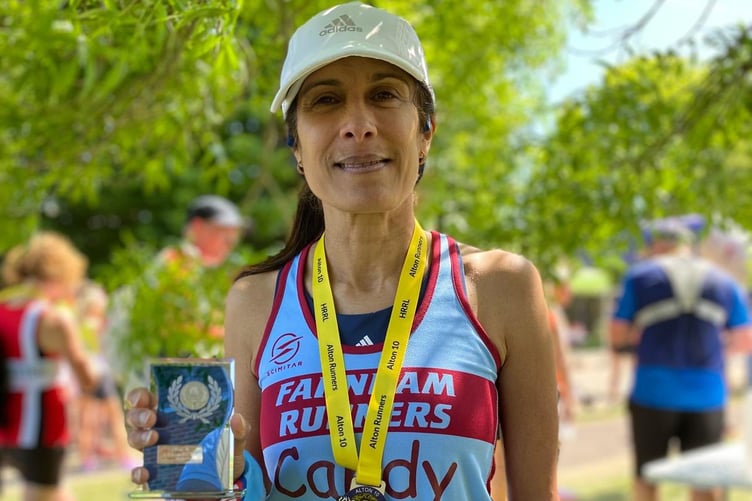 Candy Waller with her medal, trophy and prize