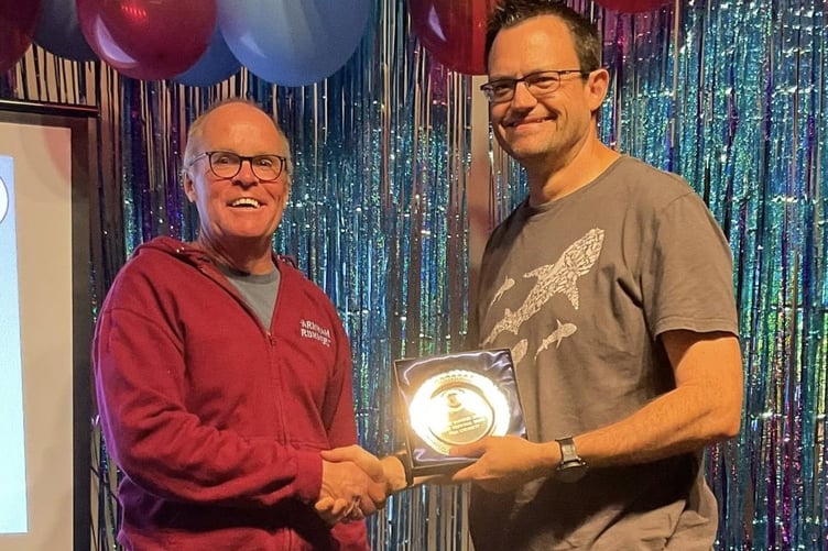 Justin Clarke presents Ivan Chunnett with the men's award for the most personal bests