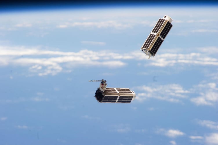 File photo of a set of NanoRacks CubeSats photographed by an Expedition 38 crew member after the deployment by the Small Satellite Orbital Deployer (SSOD), 11 Feb 2014. British researchers are working to solve the problem of Elon Musk's reflective satellites - by painting them black. A new partnership between Surrey NanoSystems and the University of Surrey is aiming to tackle the growing problem, a major concern for astronomers worldwide. Their latest innovation, Vantablack 310, is a super-black coating designed to dramatically reduce the glare from satellites that interferes with astronomical observations. Only 2% of incoming light is reflected by the surface after product is applied, while the remaining 98% is absorbed. More than 8,000 low Earth orbit (LEO) satellites already orbit Earth and projections estimate a rise to 60,000 by 2030, partly driven by the development of mega-constellations.