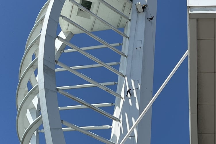 Look closely — that tiny speck clinging to the Spinnaker Tower is 80-year-old Catriona Tremlett, making her daring descent for Sarcoma UK