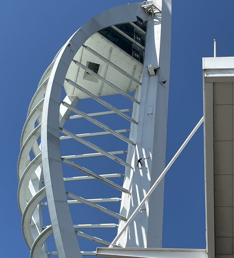 Look closely — that tiny speck clinging to the Spinnaker Tower is 80-year-old Catriona Tremlett, making her daring descent for Sarcoma UK