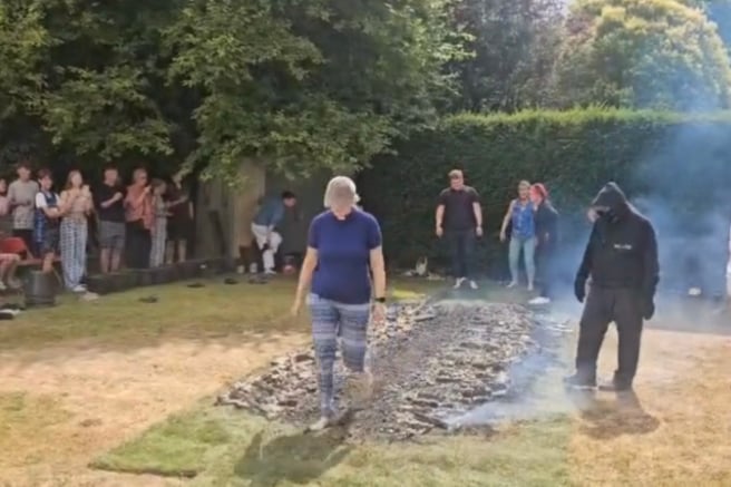 The Revd Stella Wiseman completes a charity fire walk.