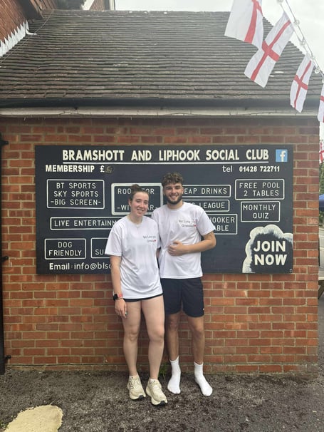 Tash and Jake Cunningham cross the finish line, completing their half-marathon in memory of their grandfather, Mick the Brick