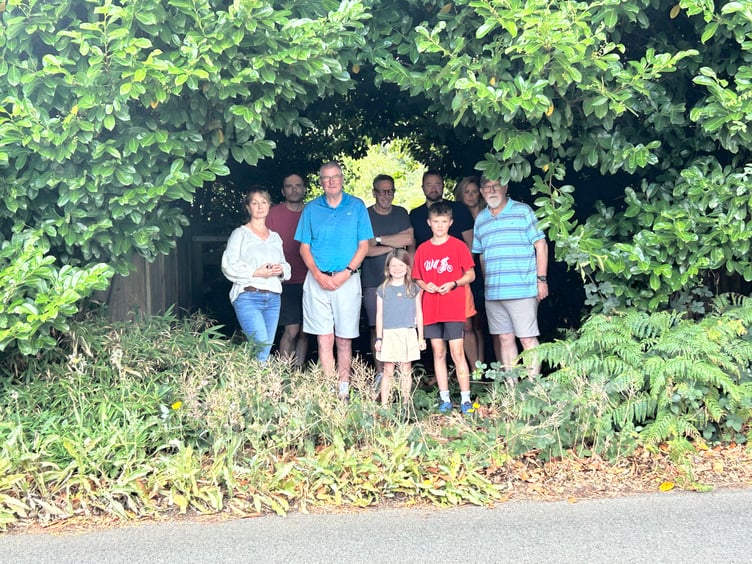 Residents gather outside the entrance to Nicols Field, where plans for new allotments have sparked anger over a lack of consultation