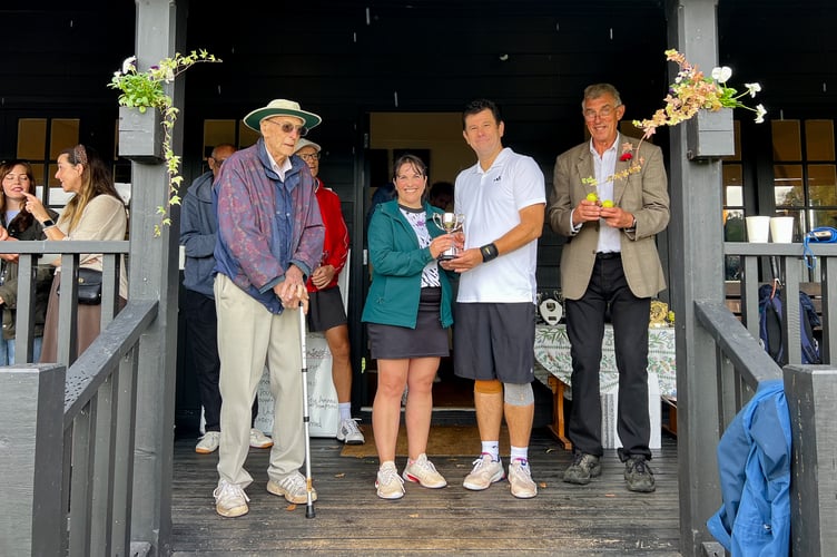 Mixed doubles champions Tessa Barrett and Matt Thompson proudly show off their trophy