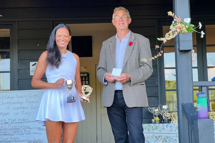 Women's singles champion Anila McDonald receives her prizes