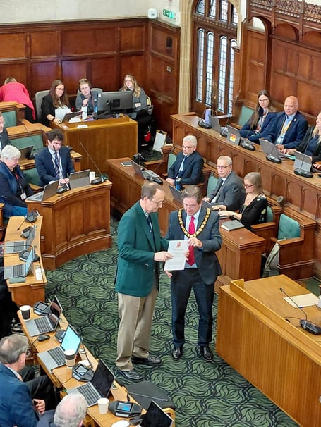 Adrian Collett at Hampshire County Council chamber receiving the honorary alderman title.