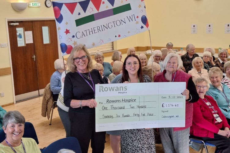 Rowans Hospice fundraiser Lilly Griffiths, centre, receives a cheque for £1,276.45 from Linda Piggott, left, and Lynne Driver, right, during the Catherington WI meeting at All Saints Church Hall on October 8th 2025.