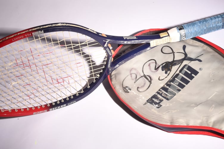 A Puma Boris Becker racquet with signed cover.