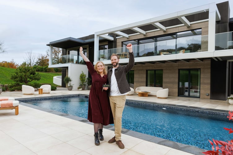 ***EMBARGO - 8:00AM GMT -NOVEMBER 7 2025 - NO ONLINE USE BEFORE THEN, FIRST PRINT USE SATURDAY NOVEMBER 8 2025***
Alistair Walker and his wife Naomi in front of the £4M property in the Surrey Hills. An NHS paramedic got the 'ultimate treat' on Halloween - winning a £4M house in the latest Omaze draw.Alistair Walker was at home expecting the knock on the door to be 'trick or treaters' - but was stunned to be told he had won the keys to a multi-award-winning smart home in the Surrey Hills.The 33-year-old, who spent nearly a decade on the frontline as paramedic and now works in NHS management, spent just £25 on his winning entry.He revealed he discovered his life-changing win on Halloween night, calling it âthe best treat Iâve ever had.â