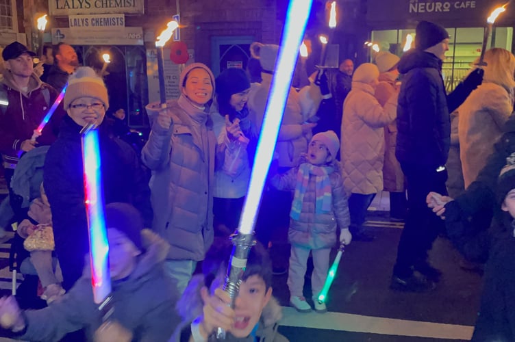Crowds enjoy the Farnham torchlit procession.